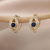 18 Karat Gold Plated button earrings against the evil eye